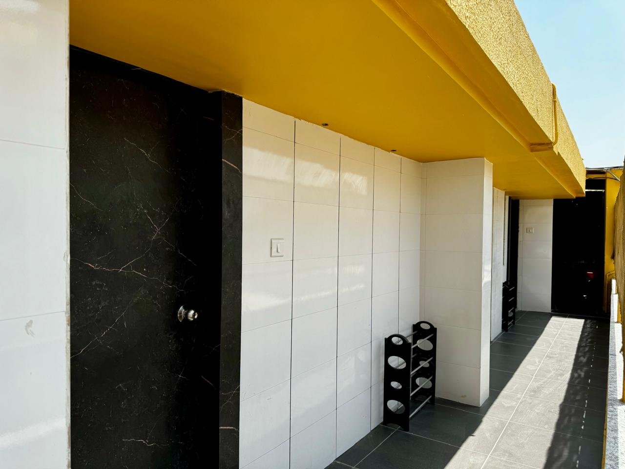 Room with three beds and ceiling fan, bright and clean