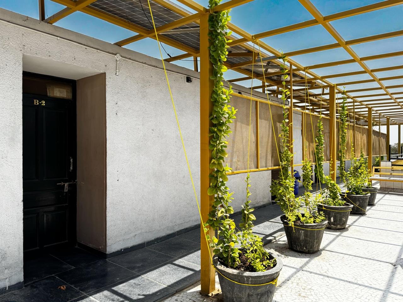 Room with three beds and ceiling fan, bright and clean duplicate image